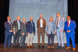 Clinton Lofts project partners standing on stage after receiving a 2025 New Jersey Future Smart Growth Award.
